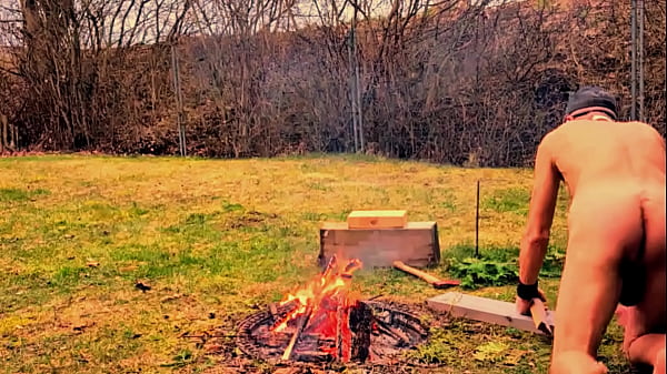 naked pathetic slave outdoor playing at the campfire with his big uncut dick