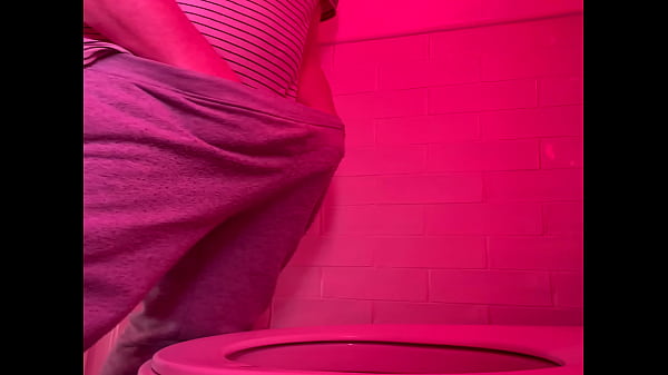 Guy pissing in the toilets of a bar