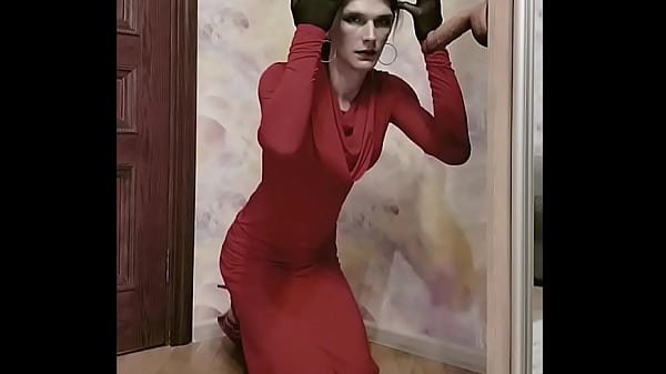 Crossdresser in elegant dress sucks big dildo