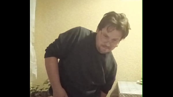 A tattooed gay man in glasses is riding a cucumber!